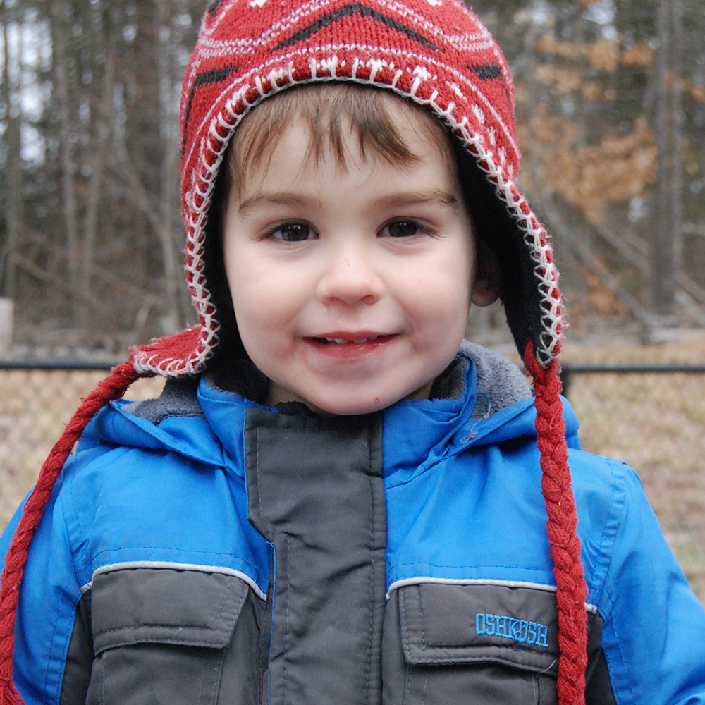 boy in winter clothes smiling